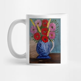 Some beautiful mixed flowers im a metallic blue jug vase . Mug